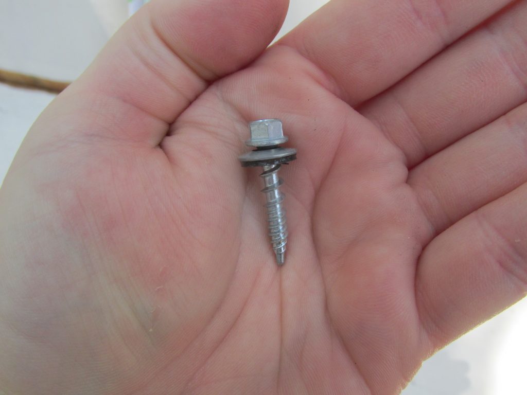 hand holding self tapping screw