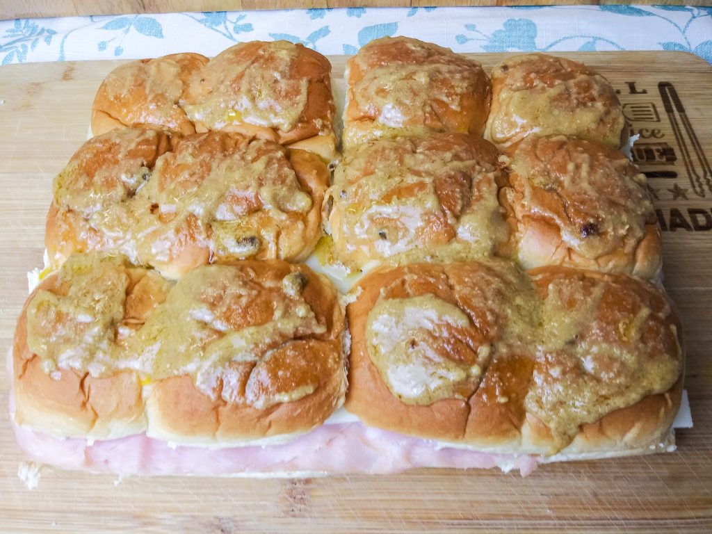 ham and cheese sliders slathered in mustard and butter mixture
