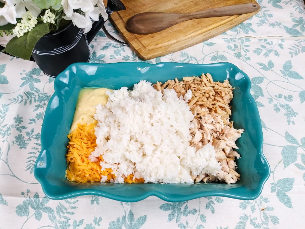 ingredients in the casserole pan with white rice on top