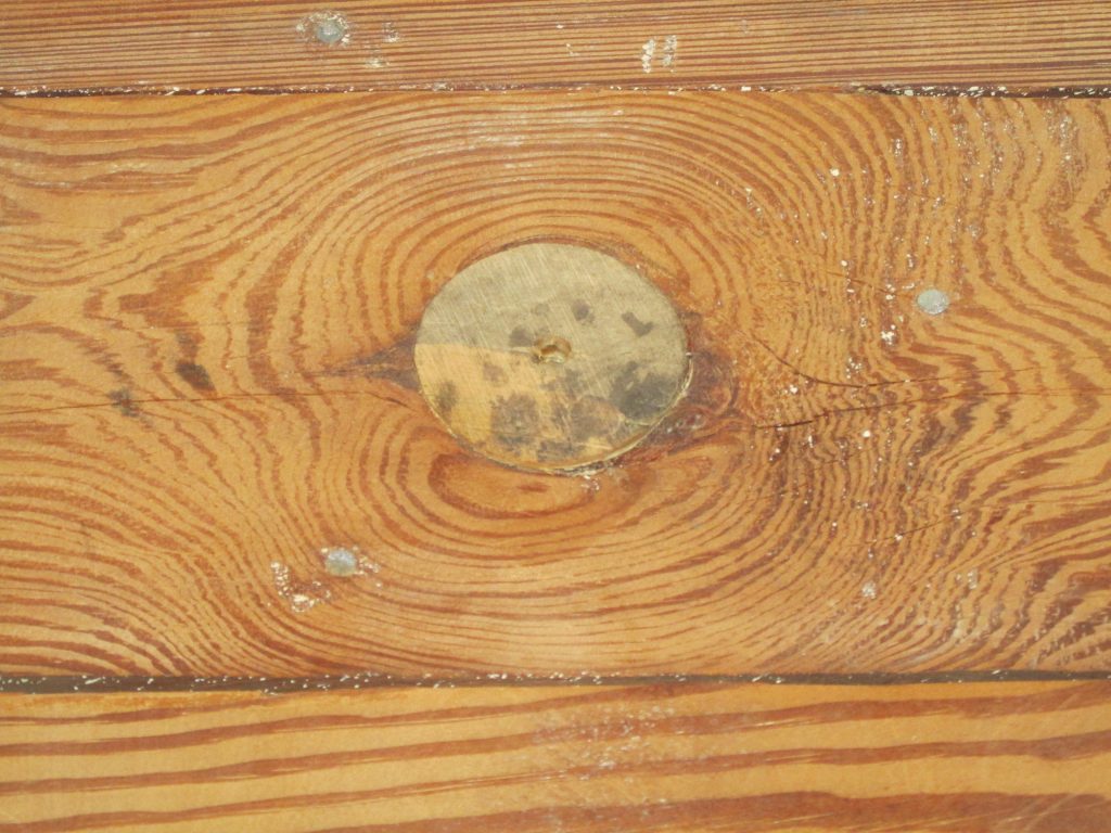 Wood wall with wood plug in knot hole